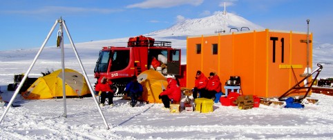 Sea-ice camp at Station II. We used the sled and the vehicles as wind barriers     Taking a break and having some hot beverages at our sea-ice camp at Station II.   We used the sled and the vehicles as a windbreak in case the weather changed.